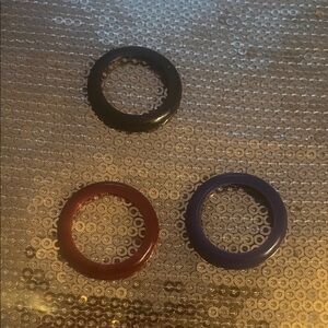 Set of Three Circular Accessories in Black, burgundy , and dark blue.